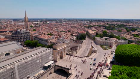 Crowd-gathering-in-the-urban-streets-of-Montpellier-for-the-2023-gaypride-aerial-rotating-view