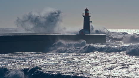 Still-landscape-shot-of-Porto-lighthouse-seawall-with-crashing-ocean-sea-waves-spray-travel-tourism-Felgueiras-Portugal-Europe-4K