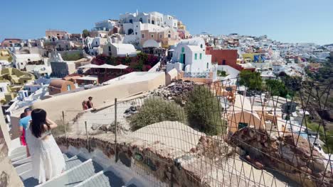 Oia-Santorini-Greece-Island-Travel-Tourist-Immersive-Walk,-Europe,-4K-|-Greek,-Aegean,-Sea,-Cliffside,-Ocean,-City,-Vacation,-Shopping,-White,-Marble,-Crowd,-Flowers,-Traveler,-People,-Stairs-Overview