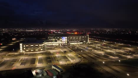 Primary-Children's-Hospital-in-Lehi,-Utah---nighttime-aerial-parallax