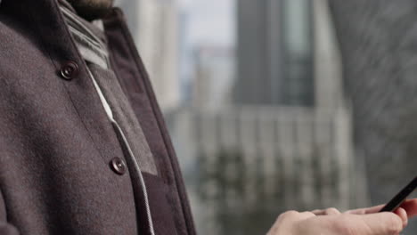 Business-man-close-up-chatting-texting-with-smartphone,-caucasian-male-model-wearing-fancy-winter-modern-clothing