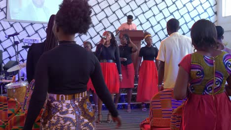 Pretty-African-woman-singing-with-microphone-in-gospel-choir