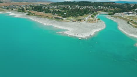 Lake-Tekapo-aqua-water-rock-shore-line-drone-shot