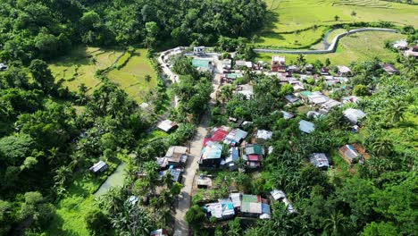 Overhead-aerial-drone-shot-of-scenic-remote-village-and-rice-paddies-in-Catanduanes,-Philippines
