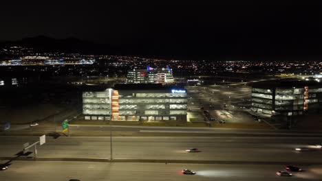 Silicon-slopes-in-Lehi,-Utah-at-nighttime---sliding-aerial-along-I-15-highway