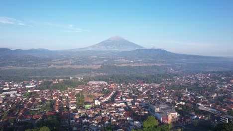 Morning-aerial-view-of-Mount-Sumbing-seen-from-the-dense-city-of-Magelang