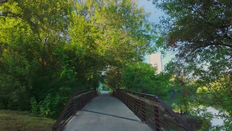 Walking-a-bridge-in-Bayou-Buffalo-Park-in-Houston,-Texas