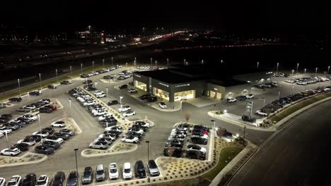 Jaguar-and-Land-Rover-luxury-car-dealership---aerial-nighttime-establishing-shot