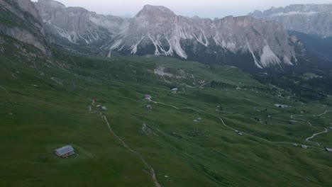 Green-fields-filmed-in-the-mountains-in-Italian-alps,-Dolomites-with-drone
