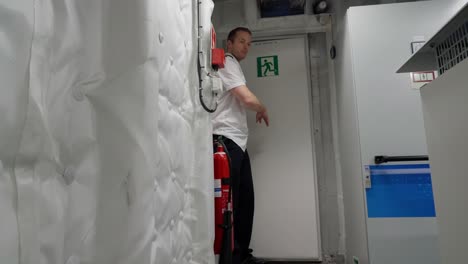Captain-demonstrate-emergency-exit-escape-route-from-ship`s-engine-room