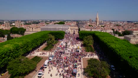 Aerial-view-over-gaypride-parade-event-in-the-gardens-of-Peyrou-with-the-cityscape-in-the-background