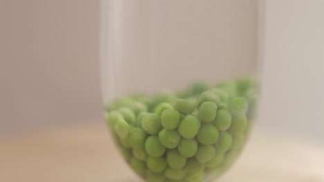 Green-Peas-dropping-in-a-still-water-and-shot-on-4K-and-RAW-with-Cine-style-on-a-white-background