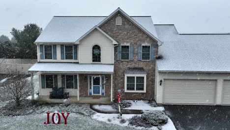 Snow-flurries-over-home-decorated-for-Christmas-in-America