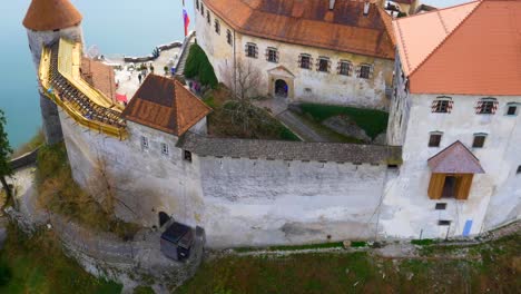 Drone-forward-flying-view-of-Bled-castle-and-lake-reveal
