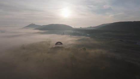 Aerial-view-of-morning-sunlight-with-fog-covered-racing-polygon-track