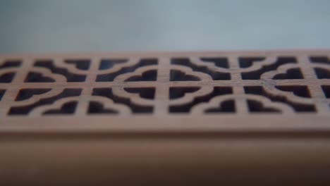 A-close-up-macro-shot-of-smoking-incense-in-a-wooden-box,-spiritual-ritual-meditation,-scented-therapy-fragrance,-relaxing-aromatic-white-smoke,-textured-case,-cinematic-static-slowmo-video-120-fps
