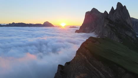 Sunrinse-filmed-at-Seceda-with-drone-in-the-italian-alps,-Dolomites-from-above-clouds
