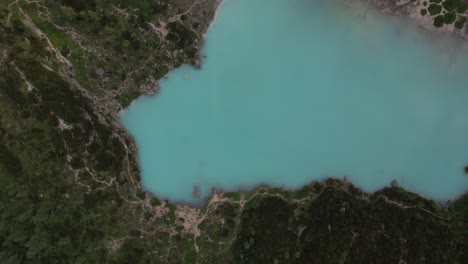 Turquoise-lake-Sorapis-filmed-top-shot-with-a-drone-in-the-Italian-alps,-Dolomites