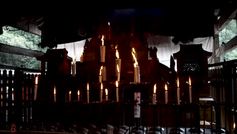 Candles-burning-with-huge-flames-inside-shrine-at-Fushimi-Inari-Taisha