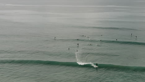 Surfers-off-the-coast-of-California,-near-San-Diego,-catch-some-waves-on-a-Sunday