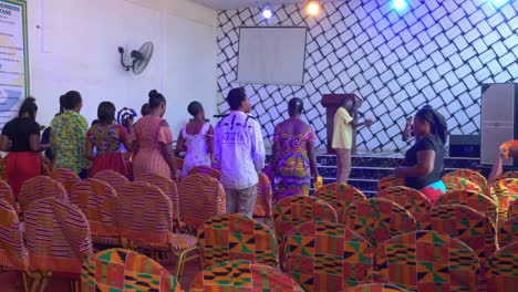 Happy-black-community-dancing-timidly-while-a-man-sings-in-the-church's-gospel-choir