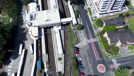 Drone-aerial-Gosford-city-train-pulling-into-platform-station-railway-line-transport-infrastructure-travel-Central-Coast-Sydney-Australia-4K