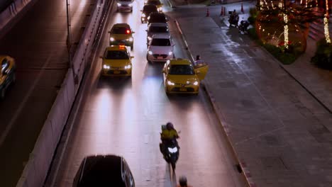 Late-night-traffic-situation-in-a-busy-street-in-the-middle-of-the-city-of-Bangkok,-Thailand