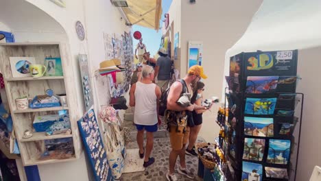 Oia-Santorini-Greece-Island-Travel-Tourist-Immersive-Walk,-Europe,-4K-|-Greek,-Aegean,-Sea,-Cliffside,-Ocean,-City,-Vacation,-Shopping,-White,-Marble,-Crowd,-Flowers,-Traveler,-People,-Shop,-Market