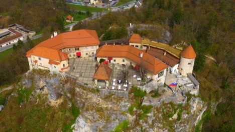 Drone-backwards-descending-moving-view-of-lake-Bled-castle
