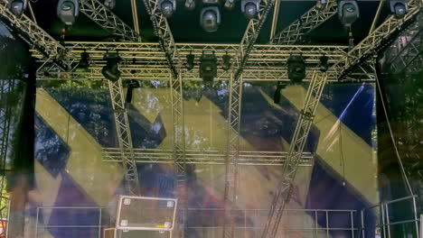 Timelapse-of-crew-setting-up-stage-background-for-musical-event-or-rock-concert