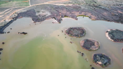 Drone-aerial-landscape-view-over-mudflat-lake-water-system-industry-agriculture-ecosystem-nature-Portugal-Europe-4K