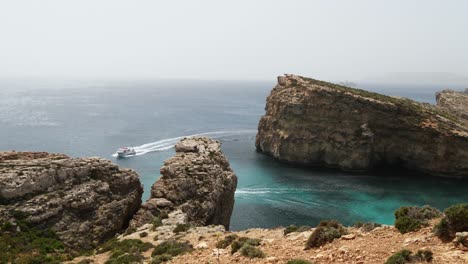 Cliffs-Of-Crystal-Lagoon-With-Tour-Boats-In-Comino-Island