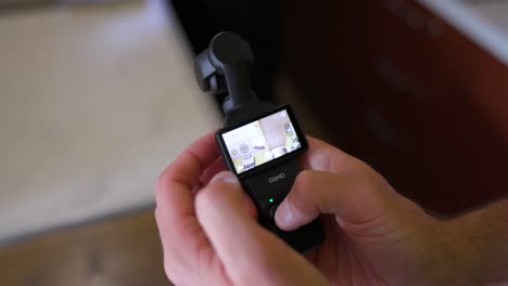 Close-up-shot-of-hand-operating-and-changing-settings-of-DJI-Osmo-Pocket-3-Gimbal-Camera