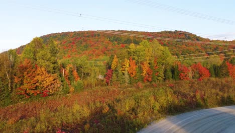 Mountain-With-Colorful-Fall-Foliage-And-High-Voltage-Transmission-Lines-In-Montreal,-Quebec,-Canada