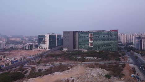 Aerial-drone-view-of-the-Deloitte-Towers-office-in-Meenakshi-Techpark-between-Mindspace-Road-and-Shilpa-Layout-Flyover-in-Hitec-City-of-Hyderabad,-Telangana