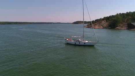 Sailboat-on-the-Baltic-sea,-Aerial,-orbit,-drone-shot,-panning-around-a-boat-in-the-finnish-archipelago,-near-Hogsara-Island,-on-a-sunny,-summer-day,-in-Varsinais-suomi,-Finland