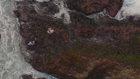 Tourists-risking-their-life-on-beach-rocks-aerial