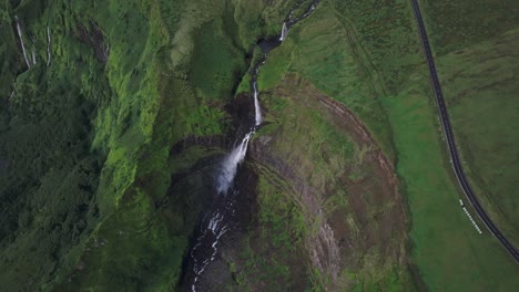 Powerful-Cascata-da-Ribeira-Grande-waterfall-from-above-in-Flores-island-Azores,-aerial