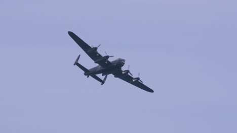Closeup-of-Avro-Lancaster-heavy-bomber-World-War-II-plane-flying-in-slow-motion,-view-from-bottom