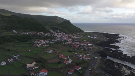 Breathtaking-Fajã-Grande-town-during-cloudy-day-at-Flores-island-Azores---Drone-shot