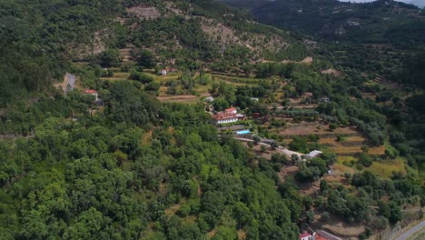 Douro-hotel,-aerial,-drone-shot,-towards-a-resort,-with-a-vineyard,-a-pool-and-orange-fruit-garden,-at-the-Duero-river,-on-a-partly-sunny-day
