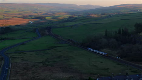 Drone-Shot-of-Passenger-Train-Travelling-Through-Yorkshire-Dales-UK