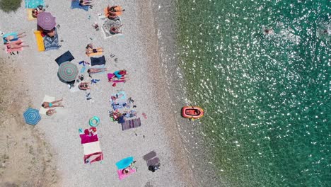 Aerial-Overhead-of-People-Sunbathing-on-Dubovica-Beach,-Hvar-Island,-Croatia