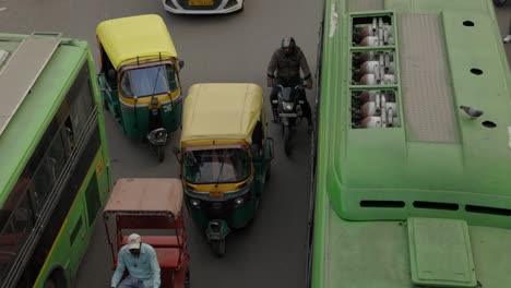 Motorbike-squeezing-through-busy-traffic,-Delhi-India