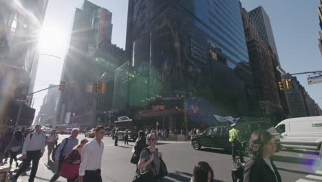 Wide-shot-tilt-up-down-slow-motion-of-pedestrian-crossing-at-busy-intersection-on-42nd-street