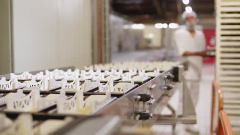 Baking-Trays-Being-Pushed-Along-Inside-French-Bread-Factory
