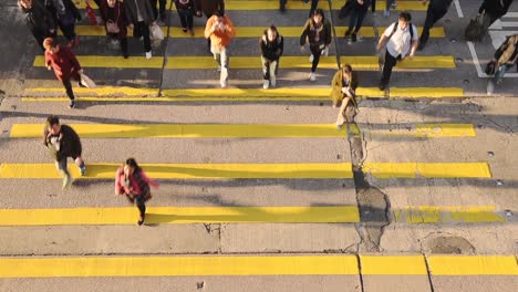 People-Crossing-On-The-Pedestrian-Lane-In-The-Street-In-Hong-Kong-On-A-Sunny-Day---Top-Shot