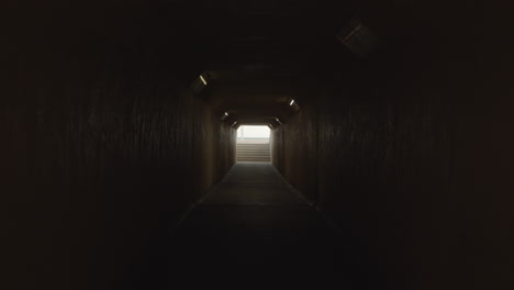 Santa-Monica's-"little-tunnel"-zooming-in-on-beach-at-the-end-of-the-tunnel-in-slow-motion-during-summer