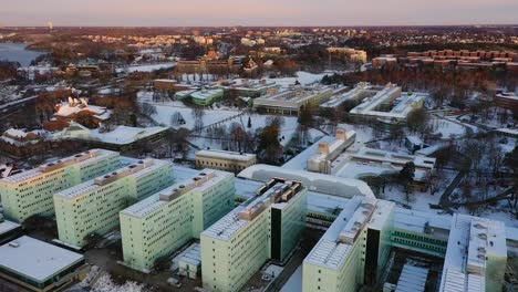 Sunrise-aerial-footage-of-Stockholm-University-covered-in-snow-in-the-month-of-December