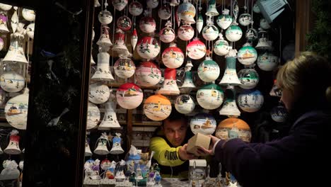 A-woman-is-buying-wooden-and-colorful-christmas-decorations-at-the-Christkindlmarket-Chicago